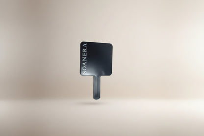 Black mirror with white logo on beige background